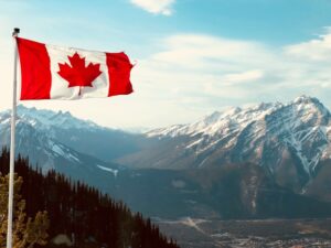 Canadian Flag in front of a mountain range