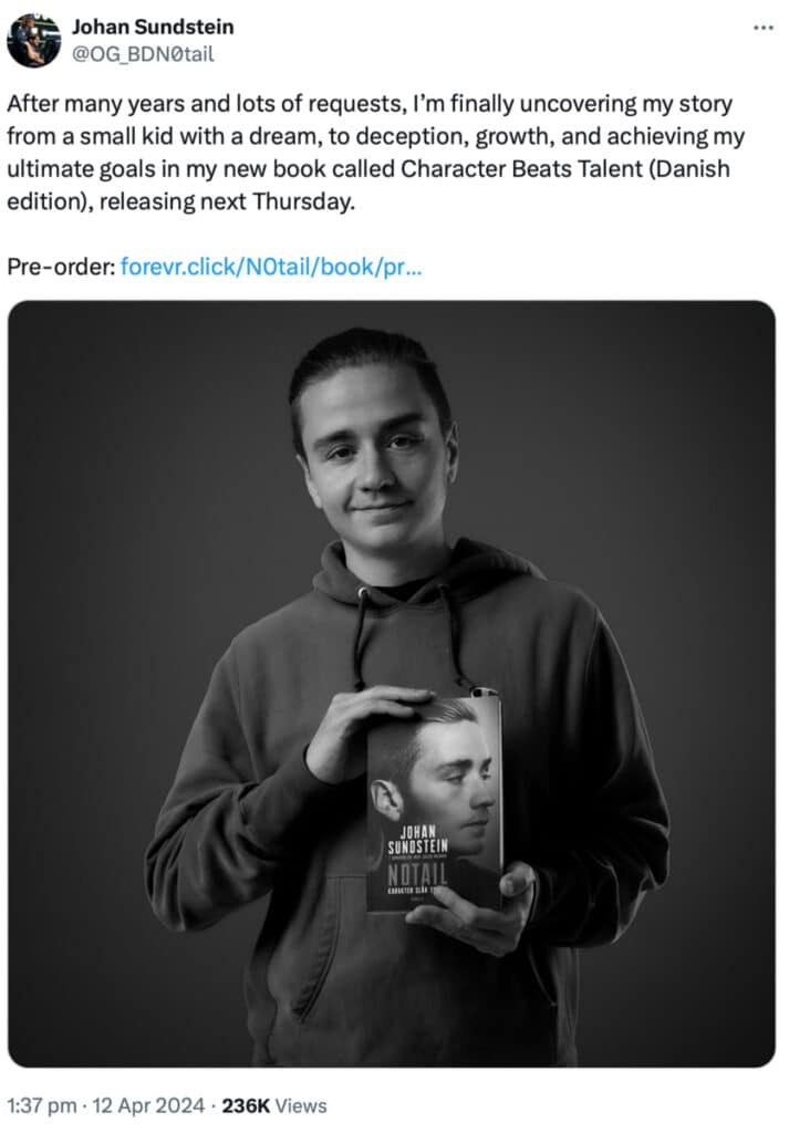 Man holding a book with his portrait on the cover.