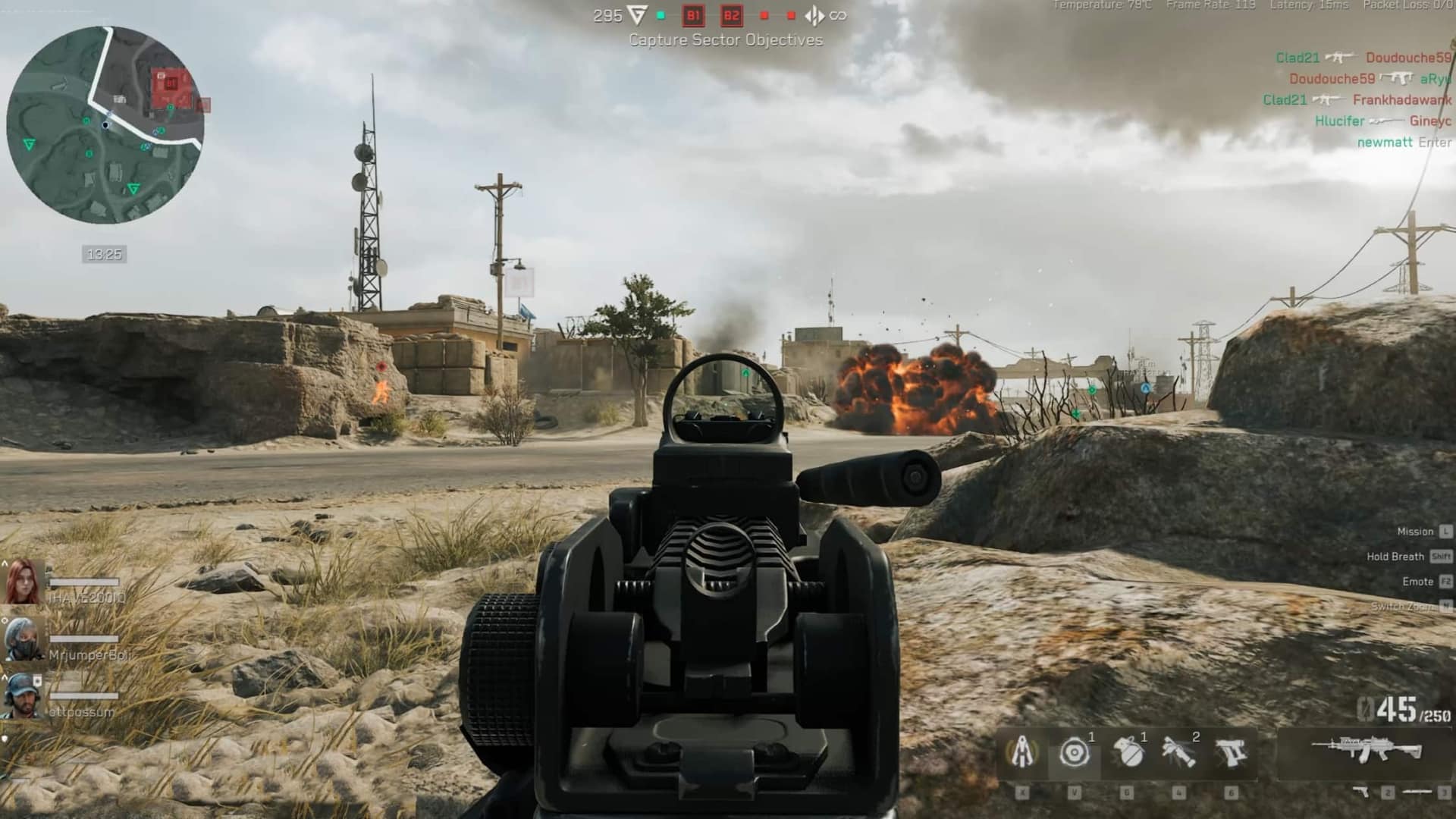 Delta Force's interface showing a player's view through a gun sight. A distant explosion occurs beside a rustic building