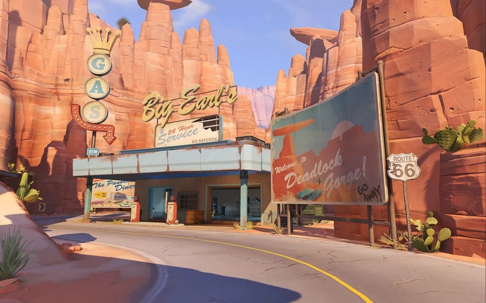 Desert gas station on Route 66, surrounded by red rock formations. Signs read "Big Earl's" and "Welcome to Deadlock Gorge"