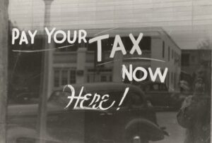 Pay your tax here now written on a window