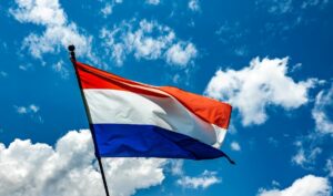 Netherlands flag with a blue sky background