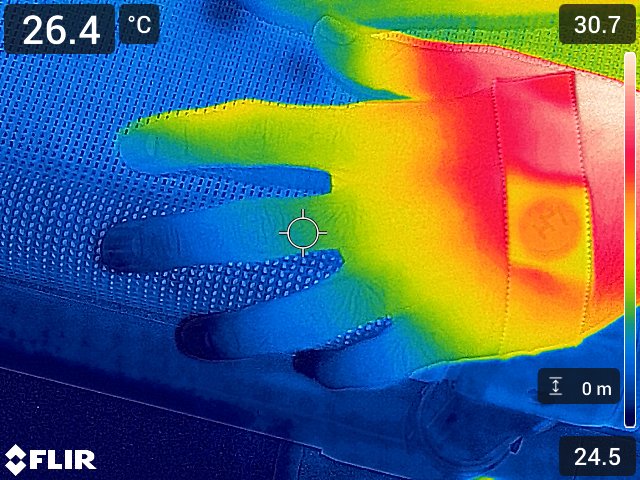 A thermal image shows a human hand during a test of extreme temperatures.